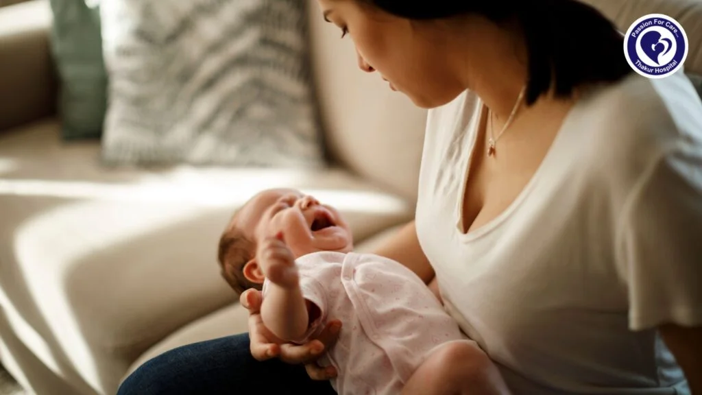 A parent comforting a crying baby at night